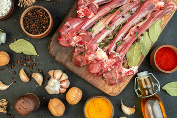 top view raw meat slice with different seasonings on dark background salad butcher cooking raw meat dish meal