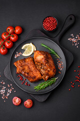 Delicious fried sea bass fish in the form of slices with spices and herbs