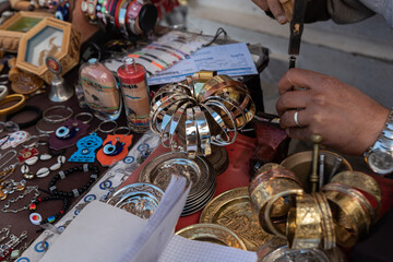 Djerba, Tunisia - April 4, 2023: Souvenirs from vacation in Tunisia. Tunisian handicrafts, metal plates with engraved illustrations.