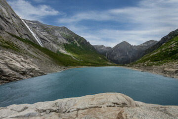 Landscape of a glacial lake with turquoise crystal clear water, Norway.