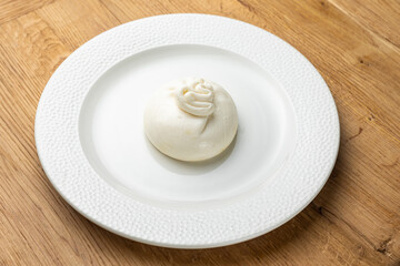 delicious buratta cheese on a white plate
