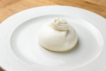 delicious buratta cheese on a white plate
