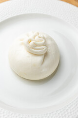 delicious buratta cheese on a white plate
