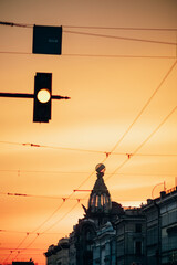 Bright orange sunset on the avenue in a large old city.