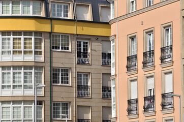 Facades of two buildings forming parallel and perpendicular lines, color contrast, city environment