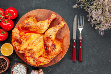top view tasty fried chicken with red tomatoes and seasonings on dark background color ripe salad bake frying dish dinner