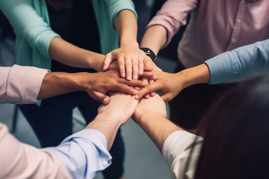 Selective focus on hands put together to show about unity, teamwork, power and success with blur background of staff. Working and Business Concept
