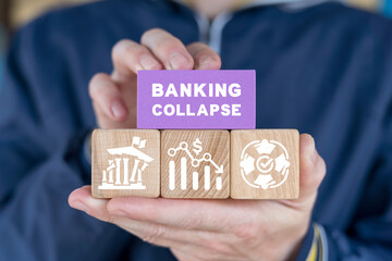 Man holding colorful blocks with icons and inscription: BANKING COLLAPSE. Banking Default, Bank Crisis with financial instability or insolvency concept as an urgent business and global market problem.