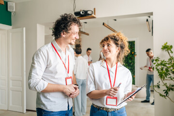 Fototapeta premium Business Partners man and woman Discuss Success While Hold Clipboard