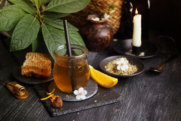 Green tea in a glass with a straw on a dark background