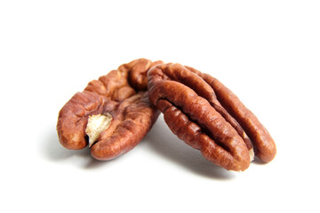 Peeled pecan nuts isolated on a white background. Heap of pecan halves