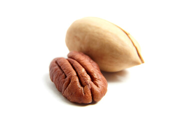 Pecan nut in shell and peeled pecan seed isolated on a white background