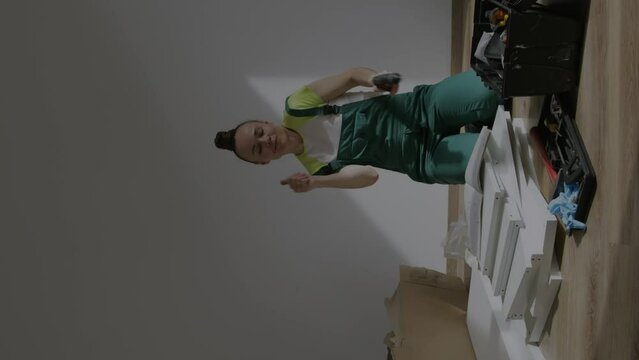 Young female is assembling a piece of furniture