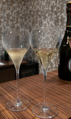 Tasting of cold brut Champagne sparkling wine in cellars of gran cru wine house in near Reims, wine tour in Champagne, France