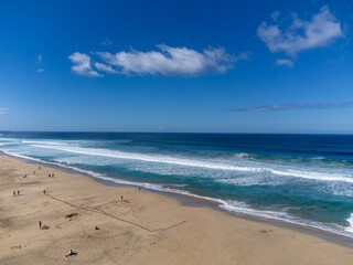 Aerial view on difficult to access golden sandy Cofete beach hidden behind mountain range on Fuerteventura, Canary islands, Spain