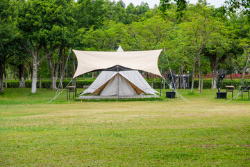 Fototapeta na wymiar Camping tents on green grass in the park