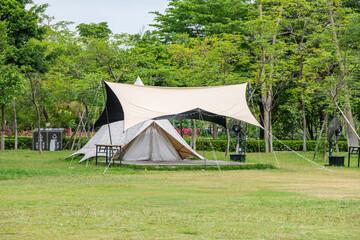 Fototapeta na wymiar Camping tents on green grass in the park