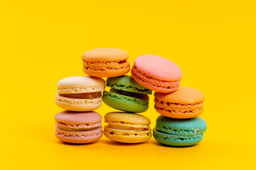 Fototapeta na wymiar a front view french macarons delicious round isolated on the yellow background cake biscuit confectionery