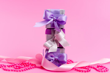 a front view purple gift boxes with bows on the pink background present gift birthday celebration