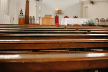 Catholic church before mass starts with empty pews