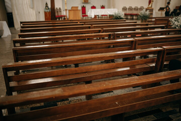 Catholic church before mass starts with empty pews