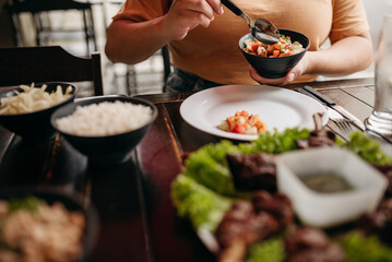 Churrasco - Barbecue Rodizio - Serving vinaigrette, rice, farofa and skewers