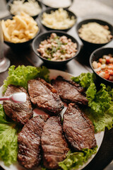 Churrasco - Barbecue Rodizio - Serving vinaigrette, rice, farofa and skewers