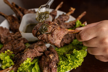 Barbecue - Grilled lamb shoulder with pesto sauce
