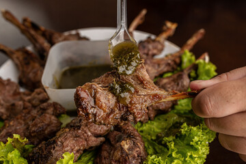 Barbecue - Grilled lamb shoulder with pesto sauce