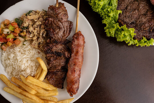 Churrasco - Prato Feito - Barbecue skewer of meat and Tuscan sausage, rice, farofa and vinaigrette