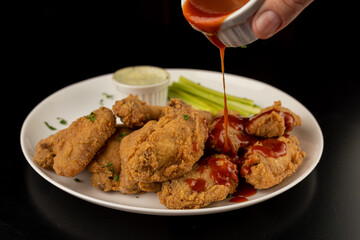 Petisco - Chicken wing seasoned and breaded with sour cream and spicy sauce