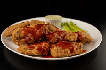 Petisco - Chicken wing seasoned and breaded with sour cream and spicy sauce