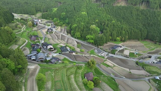 Flyover houses in traditional Japanese village with terraced rice fields