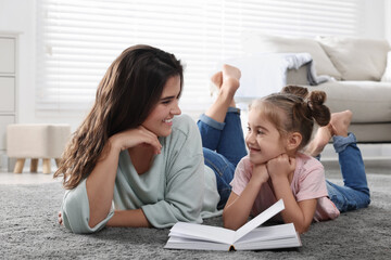 Young mother and her daughter spending time together at home