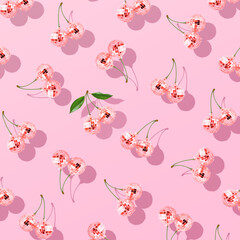 Trendy pattern composition made with Decorative disco balls like cherries on pastel pink...