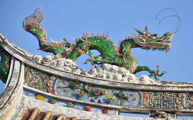Colourful traditional dragon statue on the top of a Chinese temple