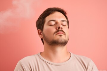 Fototapeta premium Portrait of young handsome man with closed eyes on pink background.
