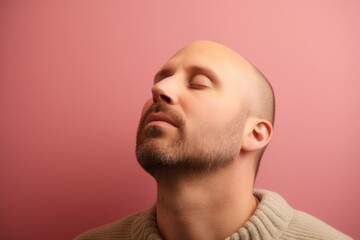 Obraz premium Portrait of a handsome young man with beard on a pink background