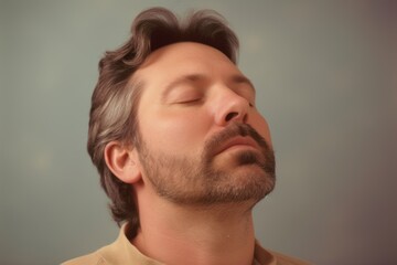 Fototapeta premium Portrait of a man with a beard on a gray background.