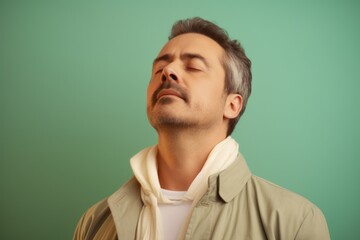 Fototapeta premium Portrait of handsome man with closed eyes on color background, closeup