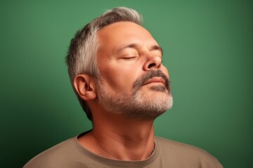 Fototapeta premium Portrait of a middle aged Asian man with grey hair and beard.
