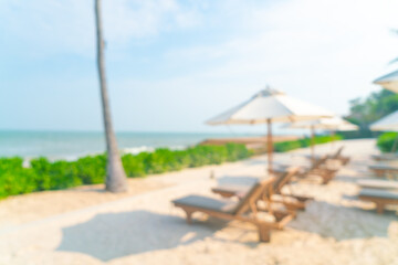 abstract blur umbrella with beach chair for background