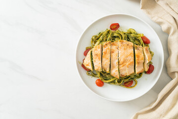 fettuccine spaghetti pasta in pesto sauce with grilled chicken