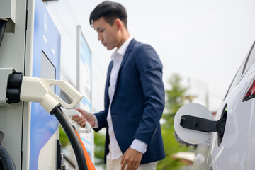 EV Car close-up photo of electric car charger connector connected to electric car Green energy concept to reduce CO2 emissions