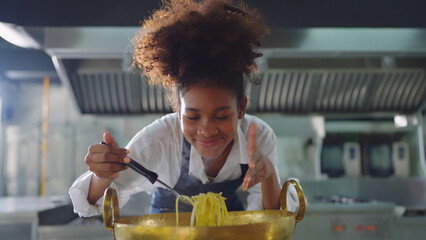Female chef working at kitchen, She cooking food for customer at restaurant kitchen. Chef, Lifestyle, Working, Teamwork and Chef table concept.