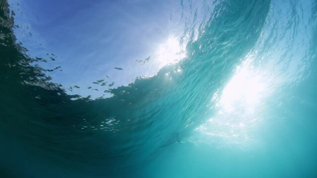 Slow Motion Shot Of Male Surfer Surfing Seen From Wavy Undersea On Sunny Day During Vacation - Oahu, Hawaii