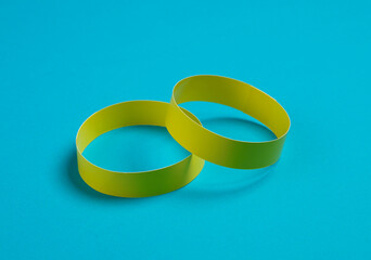 Yellow paper bracelets on a blue background