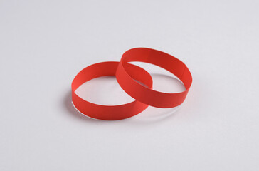 Red paper bracelets on gray background