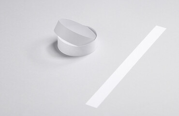 White paper bracelets on gray background