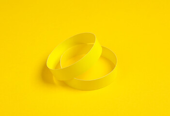 Yellow paper bracelets on yellow background
